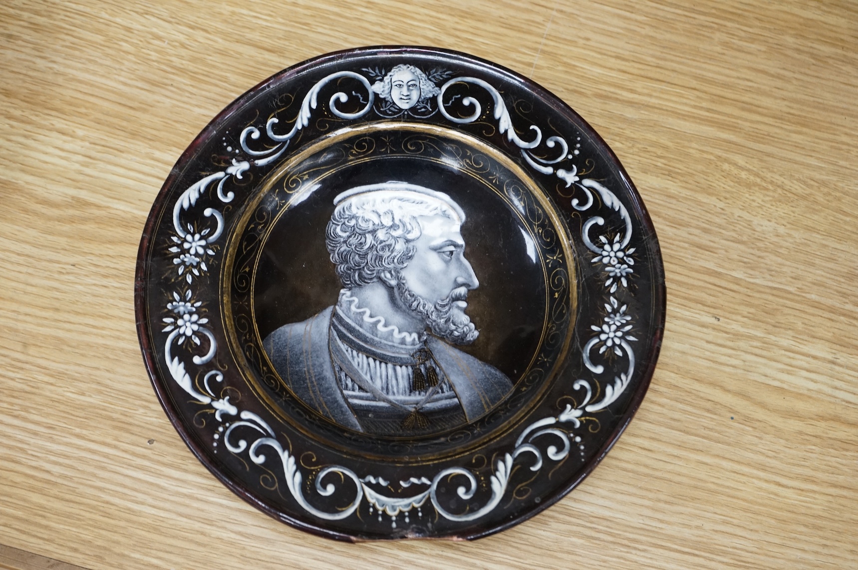 A Limoges style enamel on copper dish, decorated with a portrait of a gentleman in profile, 22cm in diameter